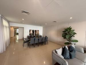 a living room with a couch and a table with chairs at 4BR Luxury Retreat & Prvt Pool in Sharm