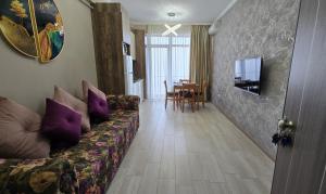 a living room with a couch and a table at Lotus 7 Silver in Mamaia