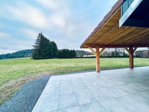 a pavilion with a view of a field and trees at Chalet familial 2-6 personnes in Champdray