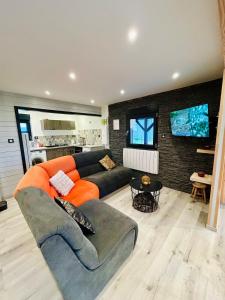 a living room with a couch and a table at Chalet familial 2-6 personnes in Champdray