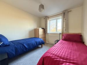 a bedroom with two beds and a window at Stunning 4 BR Townhouse for 8 With Free Parking in Dore