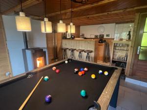 a pool table in the middle of a living room at Le Fôret - Cergnat in Le Sépey