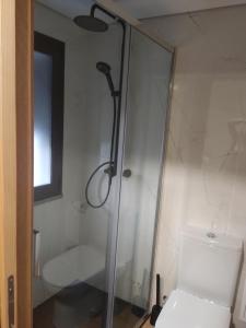 a shower in a bathroom with a toilet and a window at Casa do Moinho in Pampilhosa da Serra +4 photos
