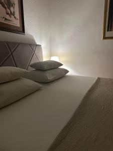 a bed with two pillows sitting on top of it at Old Town House Manosa Split in Split
