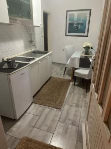 a kitchen with a sink and a table with a dining room at Old Town House Manosa Split in Split