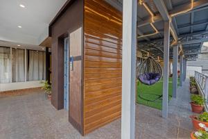 a pivot door in a lobby with a swing at Treebo Lords Garden Glory in Shimla