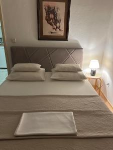 a large bed with two pillows on top of it at Old Town House Manosa Split in Split