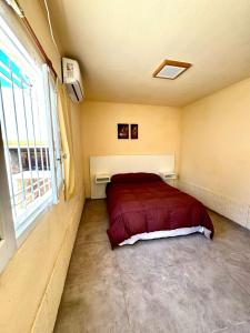 a bedroom with a bed in a room with a window at Departamento hospital Dean Funes in Deán Funes