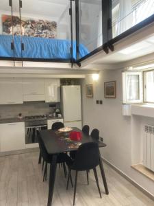 a kitchen with a table and chairs in a room at La Suite sul Mare in Crotone +16 photos