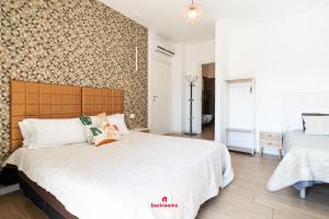 Postel nebo postele na pokoji v ubytování Barirooms - Carulli Suites