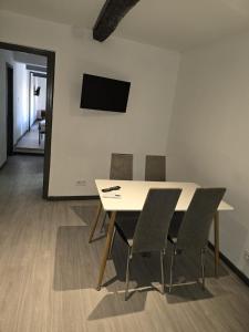 a dining room with a table and chairs and a mirror at gite atoma in Rivesaltes