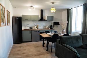 a kitchen and dining room with a table and a dining room at Jungle Room - Centre ville in Marmande