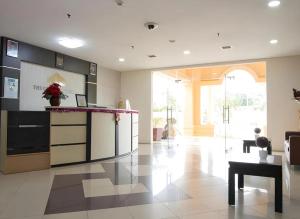 a large kitchen with a counter and a table at Queen Victoria Apartment by Sora Nest in Batam Center