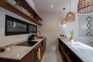 a kitchen with a sink and a counter at Moonstone - Villa with private pool and 24hrs security & Beach club access in Tulum +46 photos