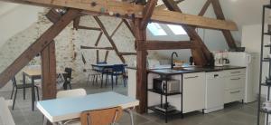 a kitchen and dining room with wooden beams at Au Lampadaire Briarois -Chambres d'Hôtes & Table d'Hôtes- in Briare