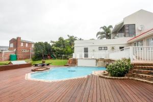 a backyard with a swimming pool and a house at Clearview Estuary Apartment 2 in East London