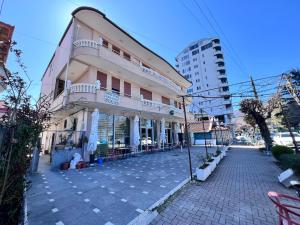 a building with a balcony on the side of a street at Vila Lacka in Pogradec
