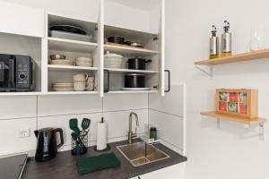 a kitchen with a sink and a counter top at SoWi Home - stilvolles Apartment mit Parkplatz - nähe Klinikum und Uni in Kassel +9 photos