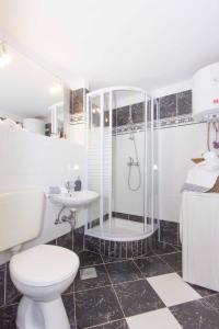 a bathroom with a shower and a toilet and a sink at Red Valentino Apartment in Split