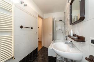 a bathroom with a sink and a shower at Appartamento Iori in Canazei +33 photos