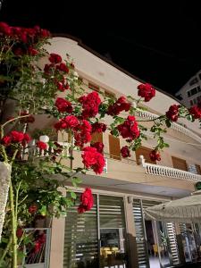 a bunch of red roses hanging from the side of a building at Vila Lacka in Pogradec
