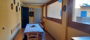 a dining room with a blue table and chairs at Cotto's house in Gerola Alta