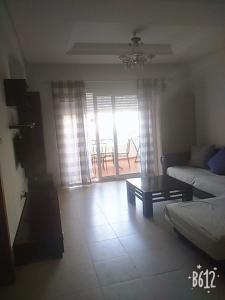 a living room with a couch and a coffee table at A base to a hassle-free getaway in El Ahmar