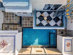 a room with a pool and a tile wall at Singh Villa Udaipur in Udaipur