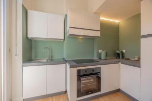 a kitchen with white cabinets and a sink at Romeo e Giulietta Suite in Verona +22 photos