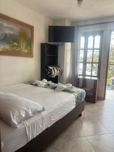 Letto o letti in una camera di Hotel Portal Guatapé