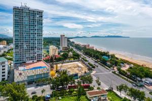 a city with a tall building next to the ocean at Condotel CSJ Vũng Tàu - Apartment Luxury CSJ Vung Tau in Vung Tau