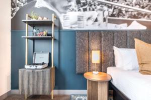 a bedroom with a bed and a table with a lamp at Chill Like Gregg Sunlit Southern Vibe in Macon