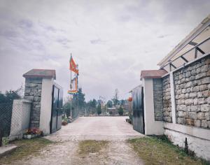 an empty street with a flag and two buildings at Rang Khem - Our Home in Tawang