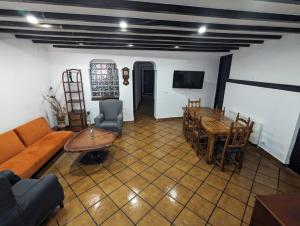 a living room with a couch and a table and chairs at Casamanchega13j in Iniesta