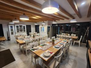 a dining room with wooden tables and chairs at A Frame Pietrele Șoimului in Cavnic