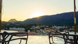 a table and chairs sitting on a patio with a view at Pousada Charme Tiradentes in Tiradentes +195 photos