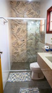 a bathroom with a shower with a toilet in it at Pousada Charme Tiradentes in Tiradentes