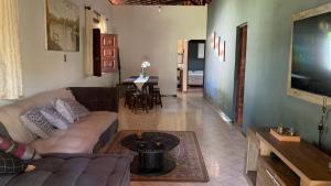 a living room with a couch and a flat screen tv at Village por do sol in Aracaju