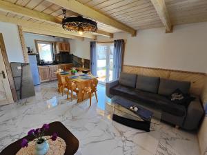 a living room with a couch and a table at Domek na Bachledowce 2 in Czerwienne