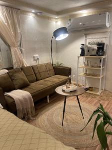 a living room with a couch and a table at كرفان العلا caravan alula in Al-ʿUla