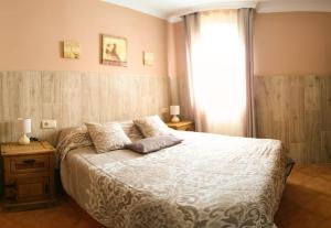 a bedroom with a large bed and a window at La Playita de Arcos in Arcos de la Frontera