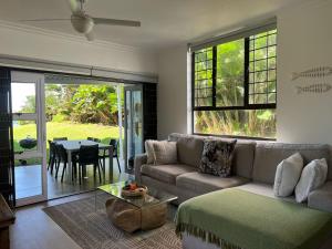 a living room with a couch and a table at Tides End in Ballito