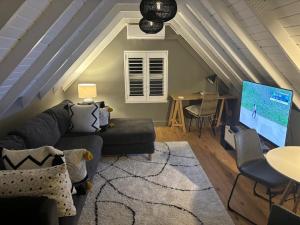 a living room with a couch and a flat screen tv at Constantia Calm, Constantia in Cape Town
