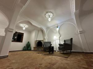 a living room with a couch and a fireplace at DAR OASIS Typical house with breathtaking views in Tangier