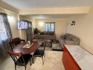 a living room with a table and a couch at Castle Berry Apartments in Kingstown