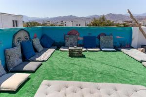 a room filled with lots of pillows on top of grass at Wanas hostel in Dahab