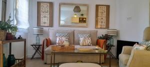 a living room with a couch and a table at Apto a estrenar 1 golf para 4p Islantilla in Isla Cristina