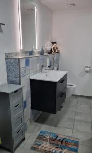 a bathroom with a sink and a toilet at Vacation home Moselsteg in Brauneberg