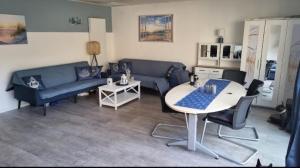 a living room with a blue couch and a table at Vacation home Moselsteg in Brauneberg