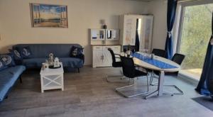 a living room with a blue couch and a table at Vacation home Moselsteg in Brauneberg +38 photos